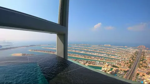 Corner of infinity pool with pillar overlooking Palm Jumeirah