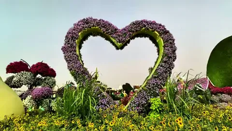 Heart-shaped floral arch above colorful flower beds at Dubai Miracle Garden