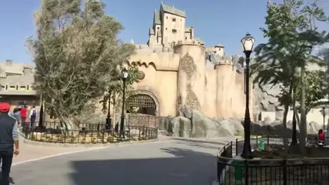 Castle-like Hotel Transylvania exterior with towers, trees, and curved path