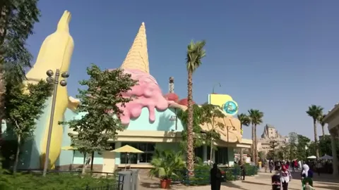 Pastel dessert-themed building with giant ice cream sculpture at Motiongate Dubai
